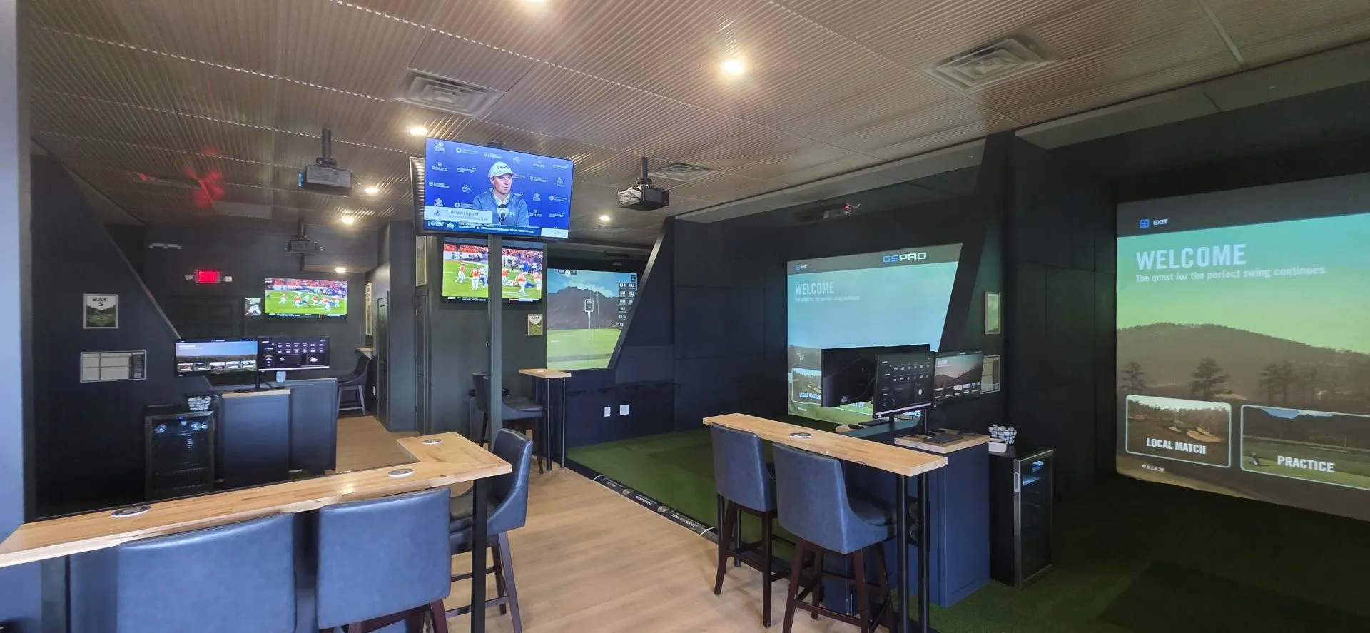 Golf simulator bays at All Seasons Indoor Golf Club in Kansas City, ready for up to four players in a BYOB-friendly facility